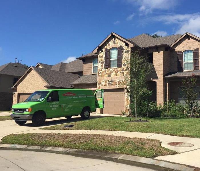 SERVPRO van parked outside a home.