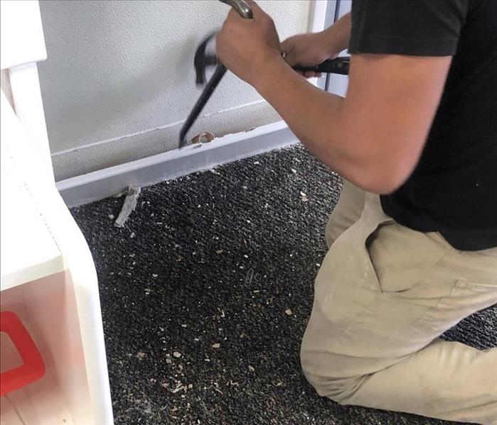 Team member removing baseboards.