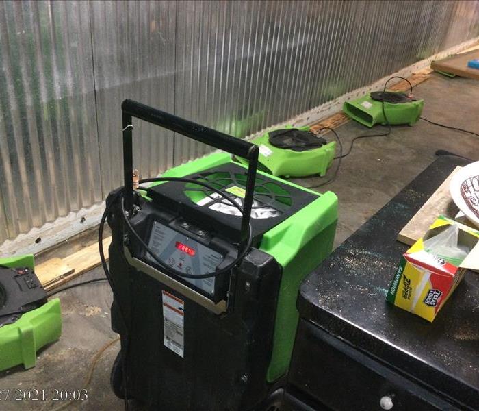 Drying equipment on warehouse floor.