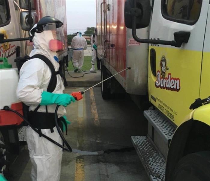 service worker cleaning crew vehicles